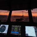 This July 2021 photo provided by Sea Shepherd shows the view from the bridge of the Ocean Warrior at sunset. Under a United Nations maritime treaty, to which China is a signatory, large ships are required to continuously use what’s known as an automated identification system, or AIS, to avoid collisions. Switching it off, except in cases of an imminent threat, for example hiding from pirates, is a major breach that should lead to sanctions for a vessel and its owner under the law of the nation to which it is flagged. (Peter Hammarstedt/Sea Shepherd via AP)