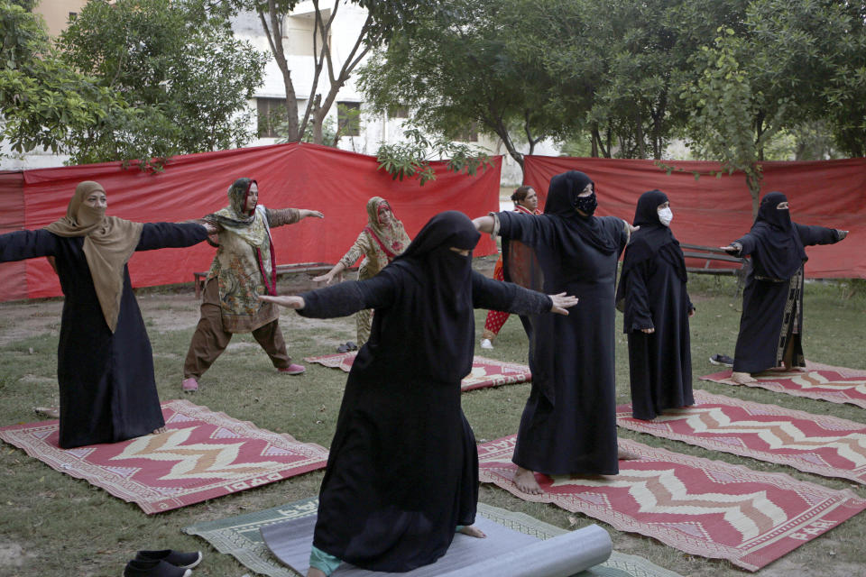 Women practice yoga on the eve of the International Yoga Day in Lahore, Pakistan, Monday, June 20, 2022. India's Prime Minister Narendra Modi, known for his reputation of an ascetic, is participating in a yoga session at the U.N. during his three-day visit to the United States. Wednesday's event is aimed to raise awareness worldwide of the benefits of practicing yoga, some nine years after the Hindu nationalist leader successfully lobbied the U.N. to designate June 21 International Yoga Day. Modi has harnessed yoga as a cultural soft power to extend his nation's diplomatic reach and assert his country's rising place in the world. (AP Photo/K.M. Chaudary)