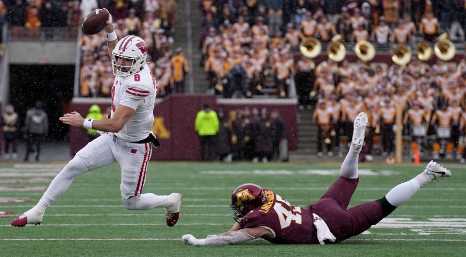 Wisconsin quarterback Tanner Mordecai gets around Minnesota linebacker Tyler Stolsky during the Badgers' 28-14 win.