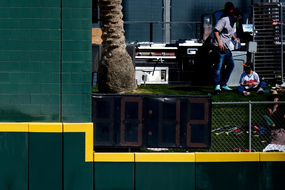 The newly instated pitch clock ticks down in right-center field during the first inning of the MLB Cactus League spring training game between the Cincinnati Reds and the Cleveland Guardians at Goodyear Ballpark in Goodyear, Ariz., on Saturday, Feb. 25, 2023.