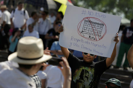 A demonstrator holds a placard reading: "No wall. Respect to immigrants and human rights" during a protest against U.S. President Donald Trump's proposed border wall and to call for unity, in Monterrey, Mexico, February 12, 2017. REUTERS/Daniel Becerril