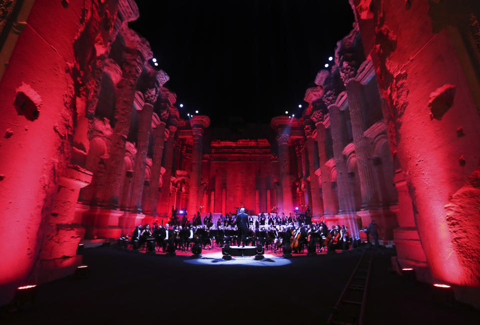 Musicians from the Lebanese Philharmonic Orchestra perform during a concert in the ancient northeastern city of Baalbek, Lebanon, Sunday, July 5, 2020. Dubbed "an act of cultural resilience," the concert aims to send a message of unity and hope to the world amid the coronavirus pandemic and an unprecedented economic and financial crisis in Lebanon. For the first time since the Baalbek International Festival was launched in 1956, this year's concert is being held without an audience, in line with strict COVID-19 guidelines. Instead, it is being broadcast live on local and regional TV stations and live-streamed on social media platform. (AP Photo/Bilal Hussein)