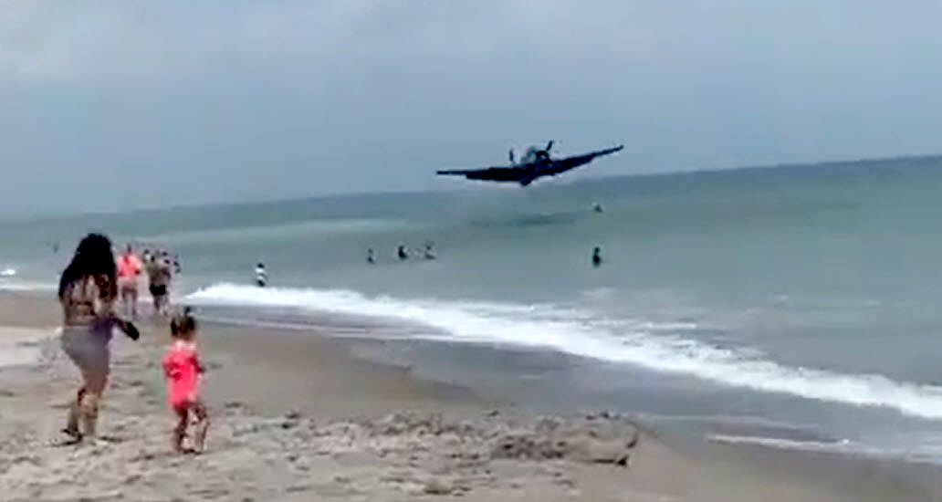 A TBM Avenger bomber flies feet above the Atlantic Ocean before landing Saturday afternoon. It did not hit any people.