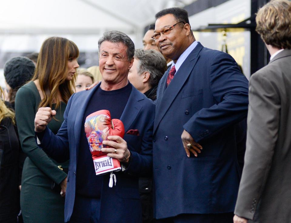 Actor Sylvester Stallone, left, and former professional boxer Larry Holmes attend the world premiere of "Grudge Match", benefiting the Tribeca Film Institute, at the Ziegfeld Theatre on Monday, Dec. 16, 2013 in New York. (Photo by Evan Agostini/Invision/AP)