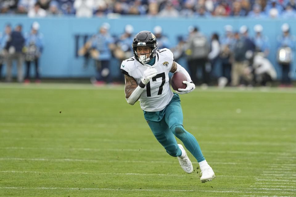 Jacksonville Jaguars tight end Evan Engram runs with the ball during the first half of an NFL football game against the Tennessee Titans Sunday, Dec. 11, 2022, in Nashville, Tenn. (AP Photo/Chris Carlson)