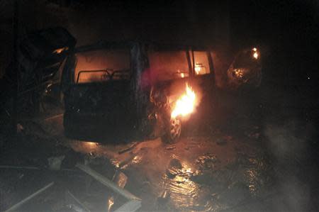 A damaged mini-van burns at the site of an explosion in the Shi'ite town of Hermel February 1, 2014. REUTERS/Rami Bleibel