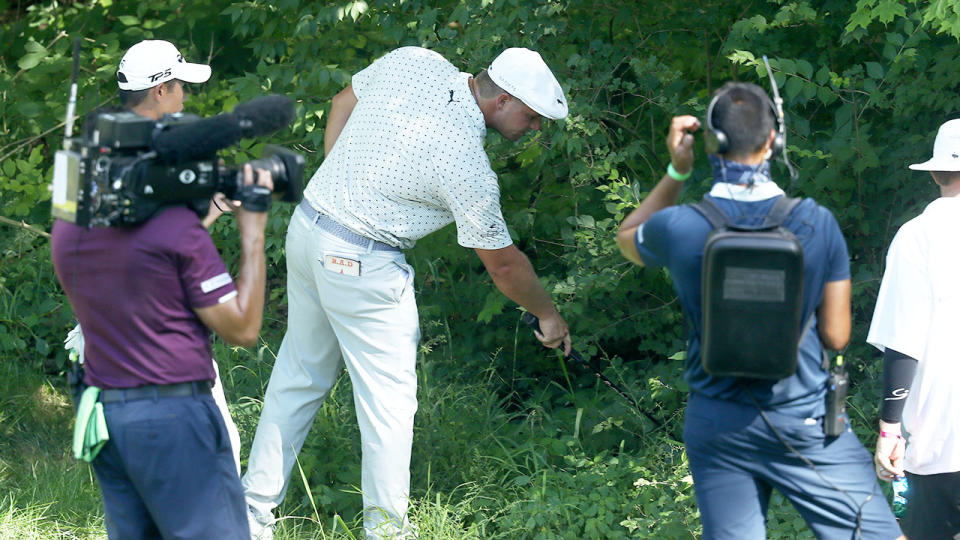 Pictured here, Bryson DeChambeau looks for his ball in the second round of the Memorial.