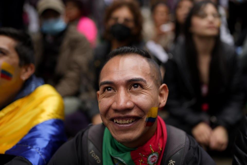 Supporters of new President Gustavo Petro watch his swearing-in ceremony on a giant TV screen near the the Bolivar square in Bogota, Colombia, Sunday, Aug. 7, 2022. (AP Photo/Ariana Cubillos)