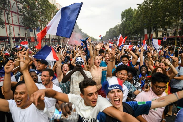 French fans on the Champs-Elysees avenue in Paris celebrate the World Cup win