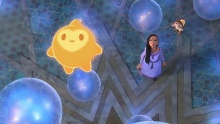 star floats above asha with the wishes in a scene from wish