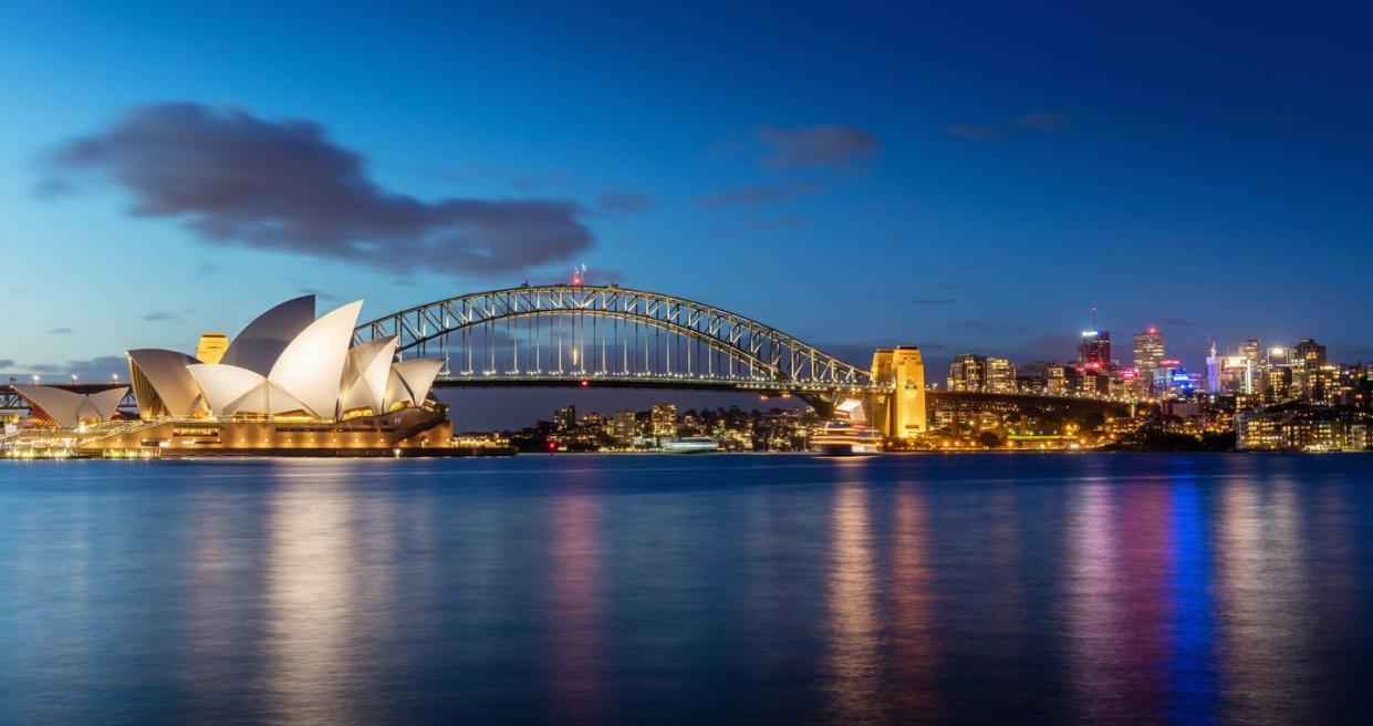 sydney skyline at twilight panorama of the sydney skyline the sydney opera house small on the left side, sydney harbour bridge in the middle twilight scenic sydney panorama sydney, australia canon 5dsr 50mpixel panorama