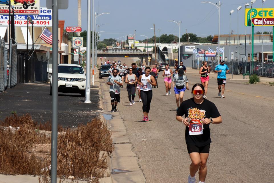 Runners run along 6th Street Saturday morning for the Fitness @ KT Black 5K/1K Run/Walk, which was part of the Texas Route 66 Festival and benefitting the Hope Lives Here organization.