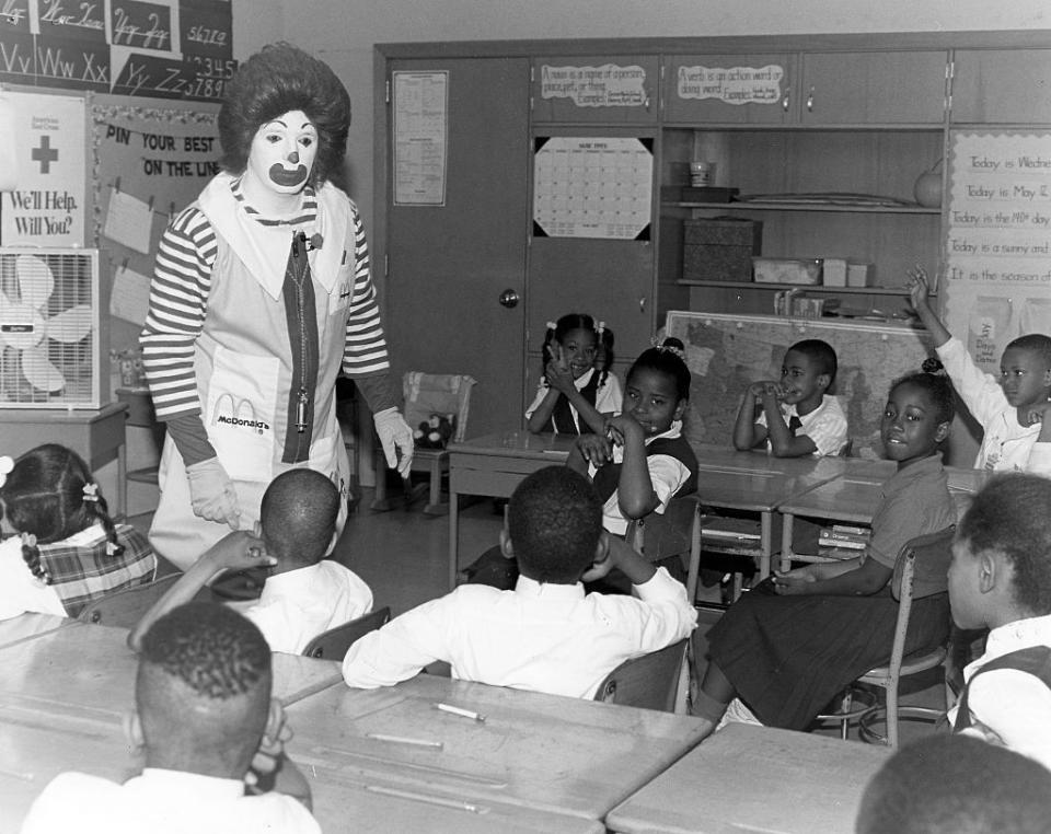 <p>Largely inspired by Bozo the Clown, the character of Ronald McDonald first appeared in advertisements on TV in 1963. The brand ambassador's full moniker was "Ronald McDonald, the Hamburger-Happy Clown." Here, an actor gives a second grade class at Grove Park Elementary School a fire safety lesson.<br></p>