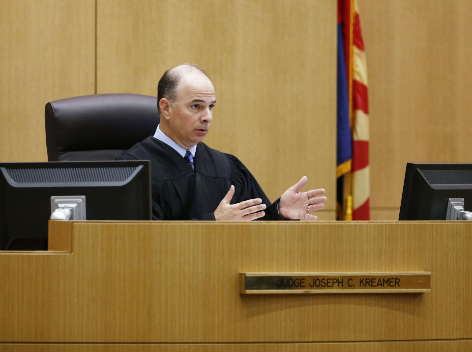 Maricopa County Superior Court Joseph Kreamer sentences Johnathan Doody on Friday, March 14, 2014 in Phoenix, Ariz. Doody, convicted of killing nine people, including six monks, during a robbery at a Buddhist temple in metro Phoenix was sentenced Friday to 249 years in prison. Doody was founded guilty in January of first-degree murder in the deaths of six monks, one nun and two helpers who were shot in the back of the head and were found arranged face-down in a circle in August 1991 at the Wat Promkunaram temple west of Phoenix. (AP Photo/The Arizona Republic, Rob Schumacher, Pool)