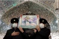 Servants of the holy shrine of Imam Reza carry the coffin of Iranian nuclear scientist Mohsen Fakhrizadeh, in Mashhad