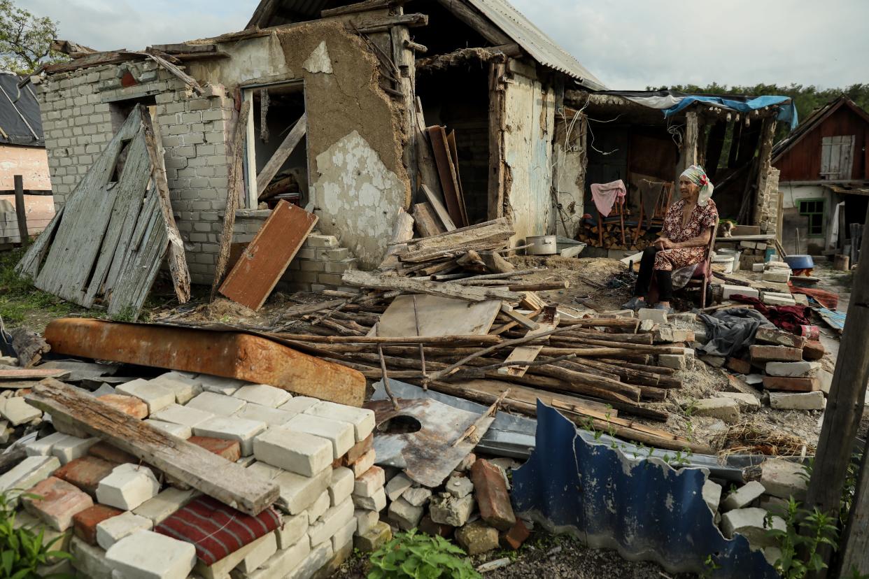 Nina, 92, sits on a chair amid the remains of her house in Bohorodychne village, Donetsk region (EPA)