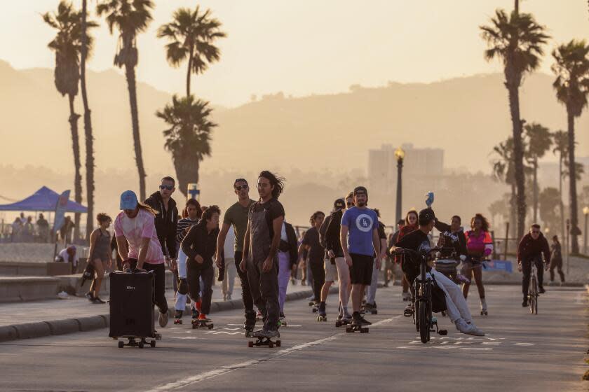 Santa Monica, CA - May 21: A group of mostly skateboarders ride along the boardwalk during a meetup with Vibe Ride LA on Tuesday, May 21, 2024 in Santa Monica, CA. The skateboard meetup is open to all skills and other forms of wheels, is free and is an extremely friendly and inclusive group. (Dania Maxwell / Los Angeles Times)