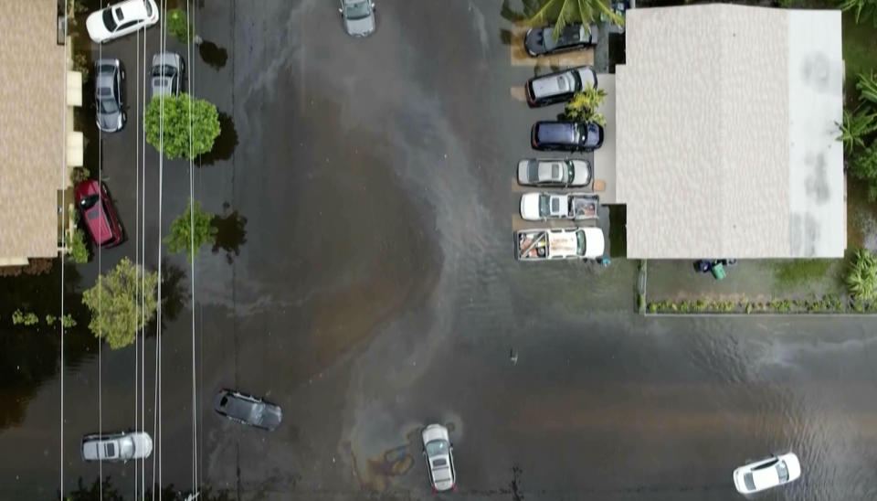 This aerial view taken from video shows multiple cars stranded on a road in Northeast Miami-Dade County, Fla., on Thursday, June 13, 2024. A tropical disturbance brought a rare flash flood emergency to much of southern Florida the day before. Floridians prepared to weather more heavy rainfall on Thursday and Friday. (AP Photo/Daniel Kozin)