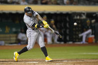 Chicago White Sox's Yoán Moncada hits an RBI double against the Oakland Athletics during the fifth inning of a baseball game in Oakland, Calif., Thursday, Sept. 8, 2022. (AP Photo/Godofredo A. Vásquez)