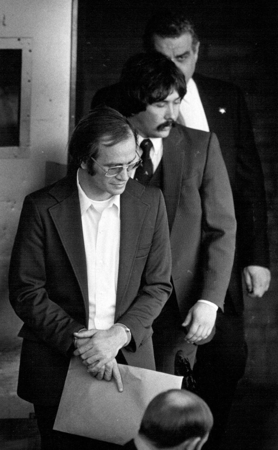 In 1983, U.S. marshals escorted James Lewis, front, out the rear door of the federal courthouse in Kansas City after he pleaded not guilty to charges of mail fraud in connection with an alleged credit card scheme and tax evasion. Frank Niemeir/The Kansas City Star