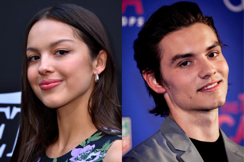 Olivia Rodrigo, left, smiling with winged eyeliner, and Louis Partridge, right, also smiling at the camera