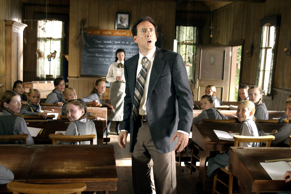 Nicolas Cage looking very disturbed in a classroom.