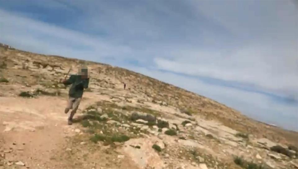 <div class="inline-image__caption"><p>A video frame grab shows an Israeli settler chasing Auren.</p></div> <div class="inline-image__credit">Cassandra Auren</div>