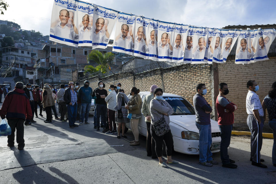 Voters up outside a polling station during general elections in Tegucigalpa, Honduras, Sunday, Nov. 28, 2021. (AP Photo/Moises Castillo)