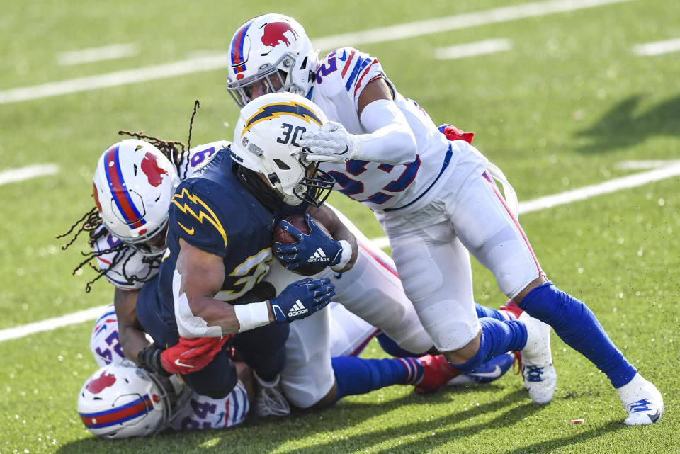 Los Angeles Chargers running back Austin Ekeler (30) is tackled on the run by Buffalo Bills strong safety Micah Hyde (23) during the first half of an NFL football game, Sunday, Nov. 29, 2020, in Orchard Park, N.Y. (AP Photo/Adrian Kraus)