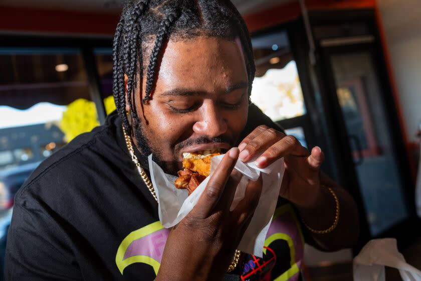 Los Angeles, CA - January 26: Danny Shell walked in off the street after seeing a high rating online and couldn't stop smiling after biting into his waffle slider at CJ's Wings, on Pico Blvd, in Los Angeles, CA, Thursday, Jan. 26, 2023. (Jay L. Clendenin / Los Angeles Times)