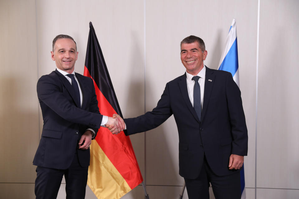 Israeli Foreign Minister Gabi Ashkenazi, right, and his German counterpart Heiko Maas shake hands during a press conference at the Ben Gurion Airport near Tel Aviv, Israel Thursday, May 20, 2021. (Abir Sultan/Pool Photo via AP)