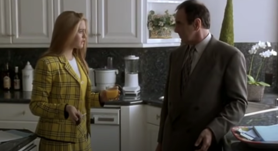 Close-up of Alicia Silverstone in a kitchen looking stunned