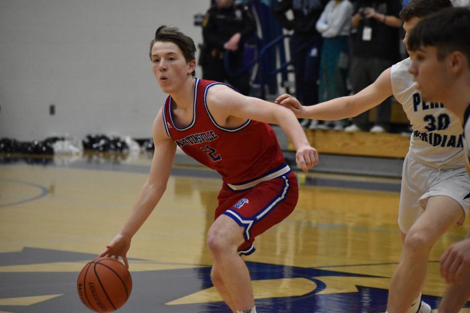 Martinsville senior Thatcher Anderson dribbles the ball and looks to pass to a teammate during their game against Perry Meridian on Jan. 21, 2022.