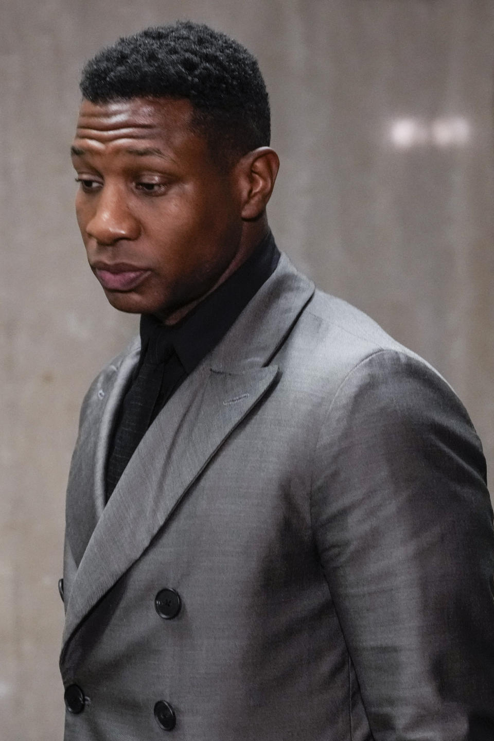 Jonathan Majors leaves a courtroom in New York, Monday, Dec. 18, 2023. Majors was convicted of assaulting his former girlfriend during a confrontation in New York City earlier this year. A Manhattan jury convicted the Marvel star Monday of one misdemeanor assault charge and one harassment violation. (AP Photo/Seth Wenig)