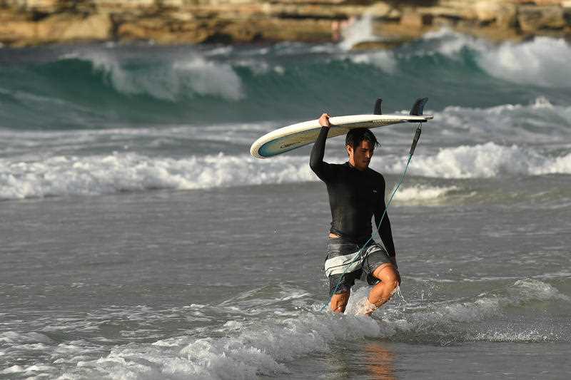 A surfer leaving the the water at Bondi Beach after it was reopened to the public.