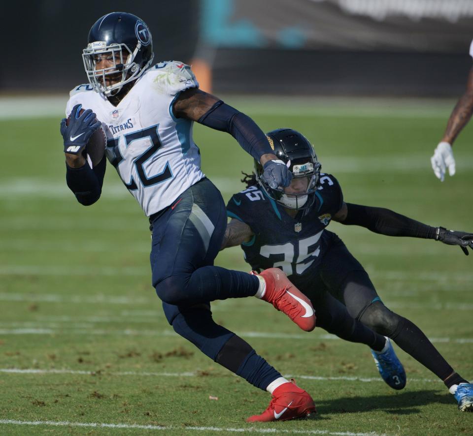Tennessee Titans running back Derrick Henry eludes former Jaguars cornerback Sidney Jones to score a touchdown during a game on Dec. 13, 2020, at TIAA Bank Field.