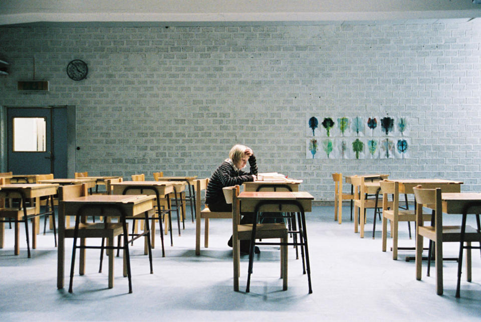 Kare Hedebrant sits at a desk in a room full of empty desks