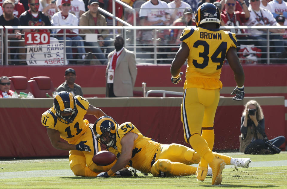 Los Angeles Rams' KhaDarel Hodge (11), Bryce Hager (54) and Malcolm Brown (34) pursue the ball after blocking a punt by San Francisco 49ers punter Bradley Pinion for a safety during the first half of an NFL football game in Santa Clara, Calif., Sunday, Oct. 21, 2018. (AP Photo/Tony Avelar)