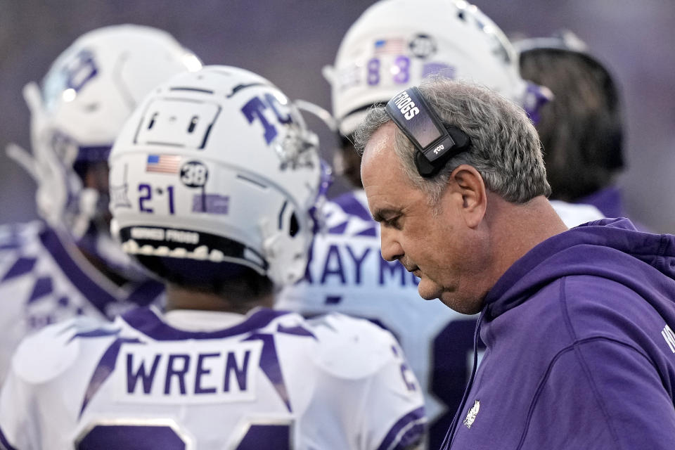 TCU head coach Sonny Dykes stands with his players during a time out in the first half of an NCAA college football game against Kansas State Saturday, Oct. 21, 2023, in Manhattan, Kan. (AP Photo/Charlie Riedel)