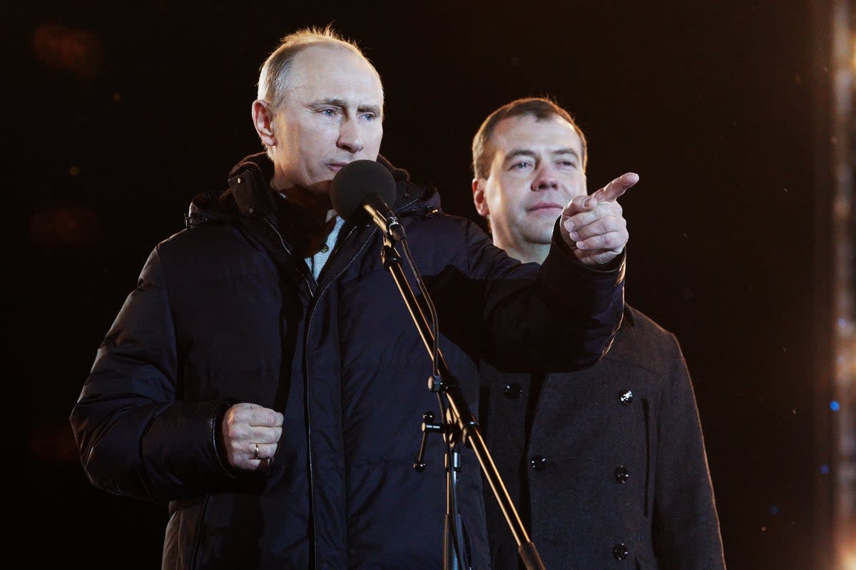 File: Russian president Vladimir Putin speaks as Dmitry Medvedev (R) listens during a rally after Putin claimed victory in the presidential election in Moscow in 2012 (Getty Images)
