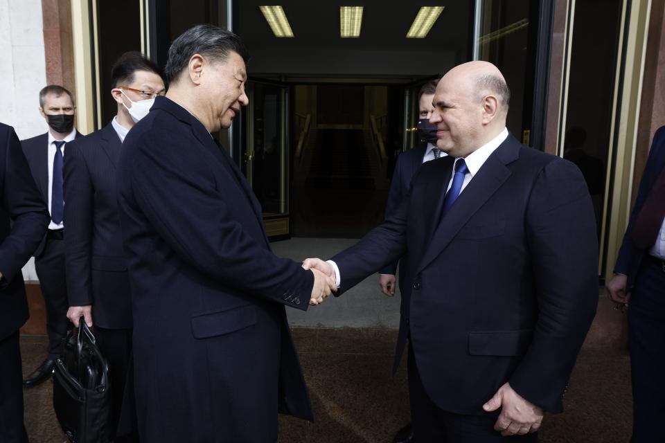 Russian Prime Minister Mikhail Mishustin, right, shakes hands with Chinese President Xi Jinping after their talks in Moscow, Russia, Tuesday, March 21, 2023. (Dmitry Astakhov, Sputnik, Government Pool Photo via AP)