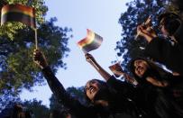 Gay rights activists wave flags as they attend a protest against a verdict by the Supreme Court in New Delhi December 11, 2013. India's Supreme Court on Wednesday reinstated a ban on gay sex in the world's largest democracy, following a four-year period of decriminalisation that had helped bring homosexuality into the open in the socially conservative country. In 2009 the Delhi High Court ruled unconstitutional a section of the penal code dating back to 1860 that prohibits "carnal intercourse against the order of nature with any man, woman or animal" and lifted the ban for consenting adults. The Supreme Court threw out that decision, saying only parliament could change Section 377 of the penal code, widely interpreted to refer to homosexual sex. Violation of the law can be punished with up to 10 years in jail. (REUTERS/Anindito Mukherjee)