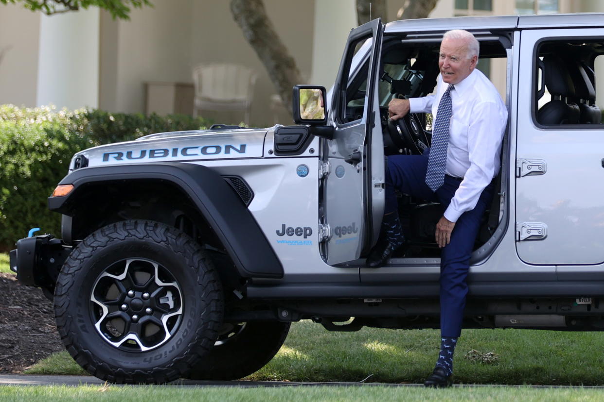 U.S. President Joe Biden hops out after test driving a Jeep Wrangler 4xe Rubicon during an event for clean cars and trucks, and signs an executive order on transformaing the country’s auto fleet at the White House in Washington, U.S. August 5, 2021.  REUTERS/Jonathan Ernst