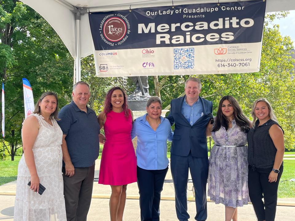 (From left to right) Thalia Amador, Small Business Administration economic development specialist; Thalia Amador, Michael Bowers, Small Business Development Center director;  Ariana Ulloa Olavarrieta, small business coordinator with the Columbus Department of Development; Ramona Reyes, program director with the Our Lady of Guadalupe Center; CAPA President Chad Whittington, Columbus City Council member Lourdes Barroso de Padilla, and Maria Cortez, assistant director of community affairs for Columbus Mayor Andrew Ginther's office, at the third annual Mercadito Raices at Festival Latino on Friday.