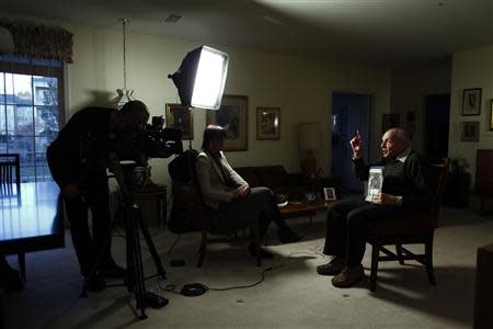 Harry Ettlinger holds a picture of himself while he speaks during an interview at his home at Rockaway in New Jersey, November 20, 2013. REUTERS/Eduardo Munoz