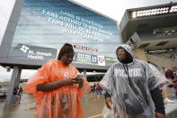 Diamond King, left, and Nykala Johnson wait for play to resume during a weather delay for an NCAA college football game between Sam Houston State and Texas A&M Saturday, Sept. 3, 2022, in College Station, Texas. (AP Photo/David J. Phillip)