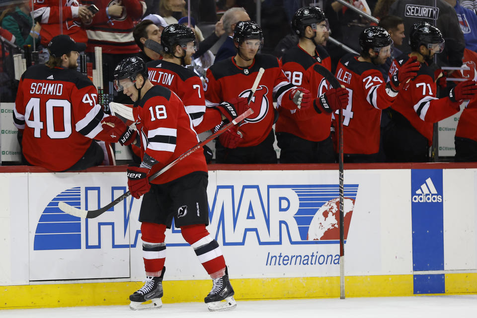 New Jersey Devils left wing Ondrej Palat (18) is congratulated for his goal against the New York Rangers during the first period of an NHL hockey game Saturday, Nov. 18, 2023, in Newark, N.J. (AP Photo/Noah K. Murray)