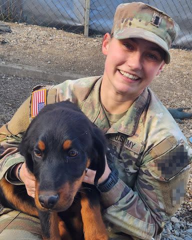 <p>Courtesy of Paws of War</p> A solider with a dog they adopted while overseas