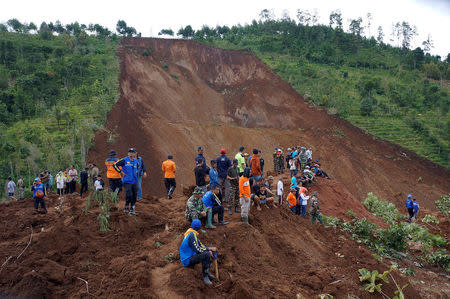 Rescuers rest during a rescue operation after a landslide triggered by heavy rain hit Banaran village in Ponorogo, East Java province, Indonesia April 2, 2017 in this photo taken by Antara Foto. Antara Foto/Destyan Sujarwoko/ via REUTERS