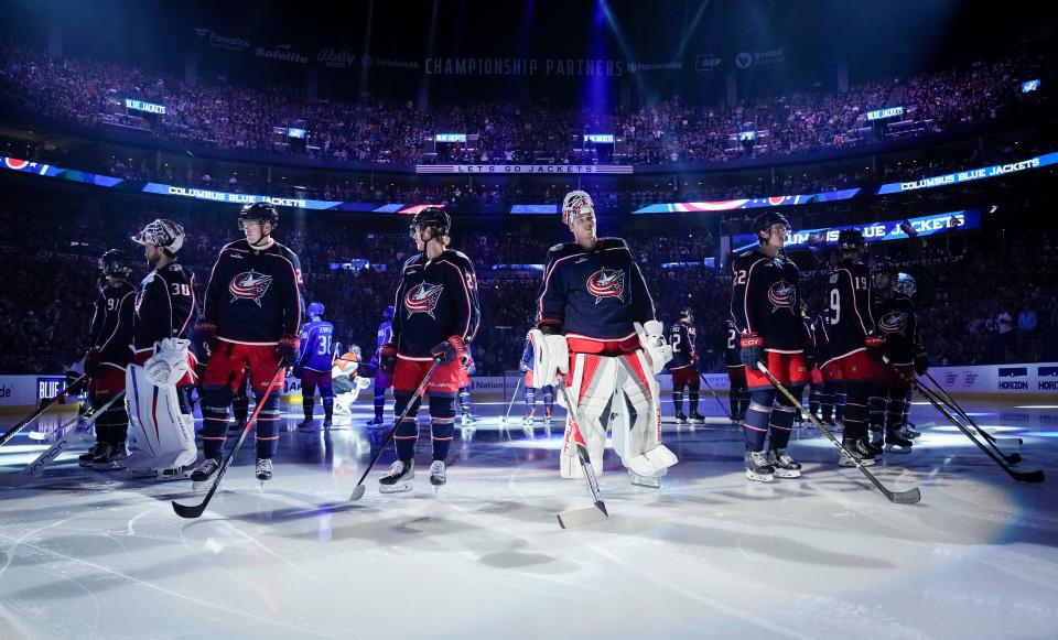 Oct 12, 2023; Columbus, Ohio, USA; The Columbus Blue Jackets stand at center ice prior to the season opener against the Philadelphia Flyers at Nationwide Arena.
